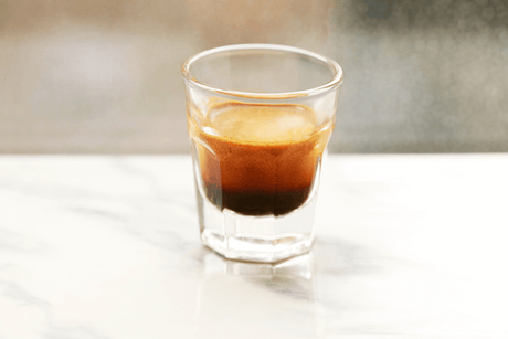 a shot of ristretto in a clear shot glass